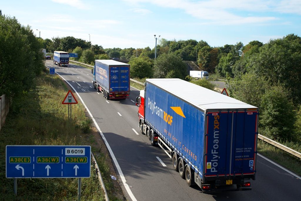 Cargo trucks moving on highway - not-for-profit freight factoring cooperative